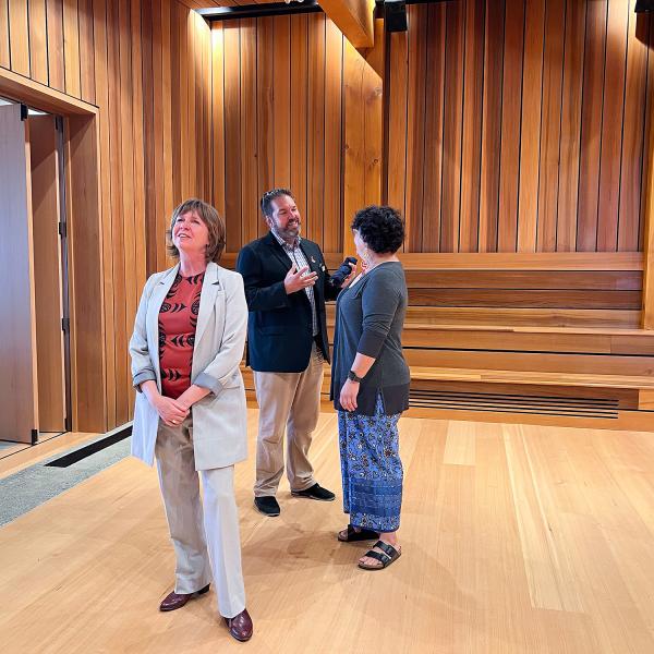 Sheila Malcolmson, MLA for Nanaimo, Richard Horbachewski and Lillian Morton tour the gathering space inside Shq’apthut