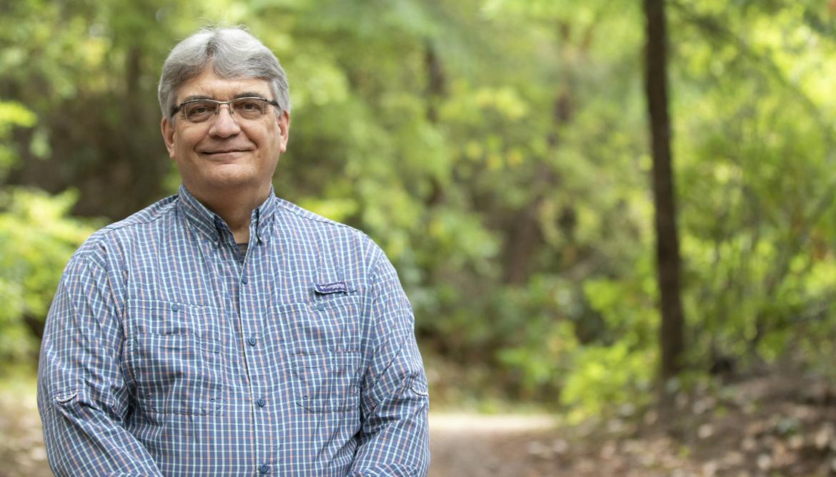 VIU Forestry Professor Bill Beese stands in front of trees.