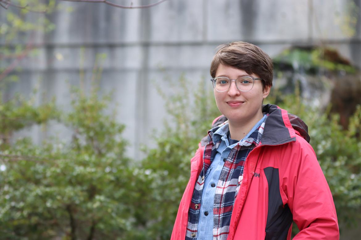 Misha Zvekic stands in a garden at VIU's Nanaimo campus.