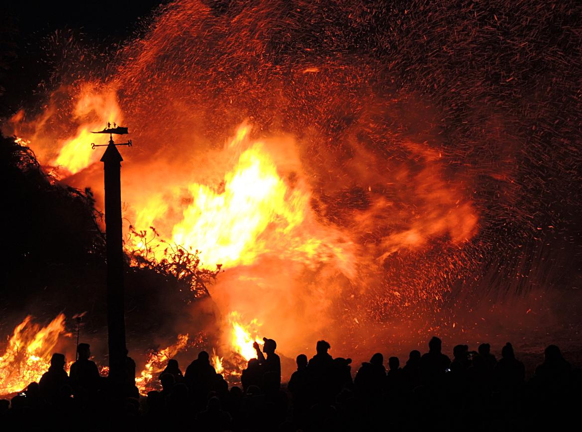 Wildfire with silhouettes of people looking on